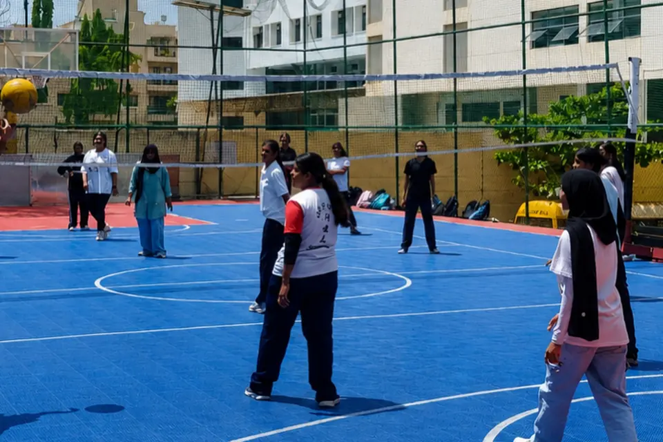 Students playing on the college's outdoor sports court.